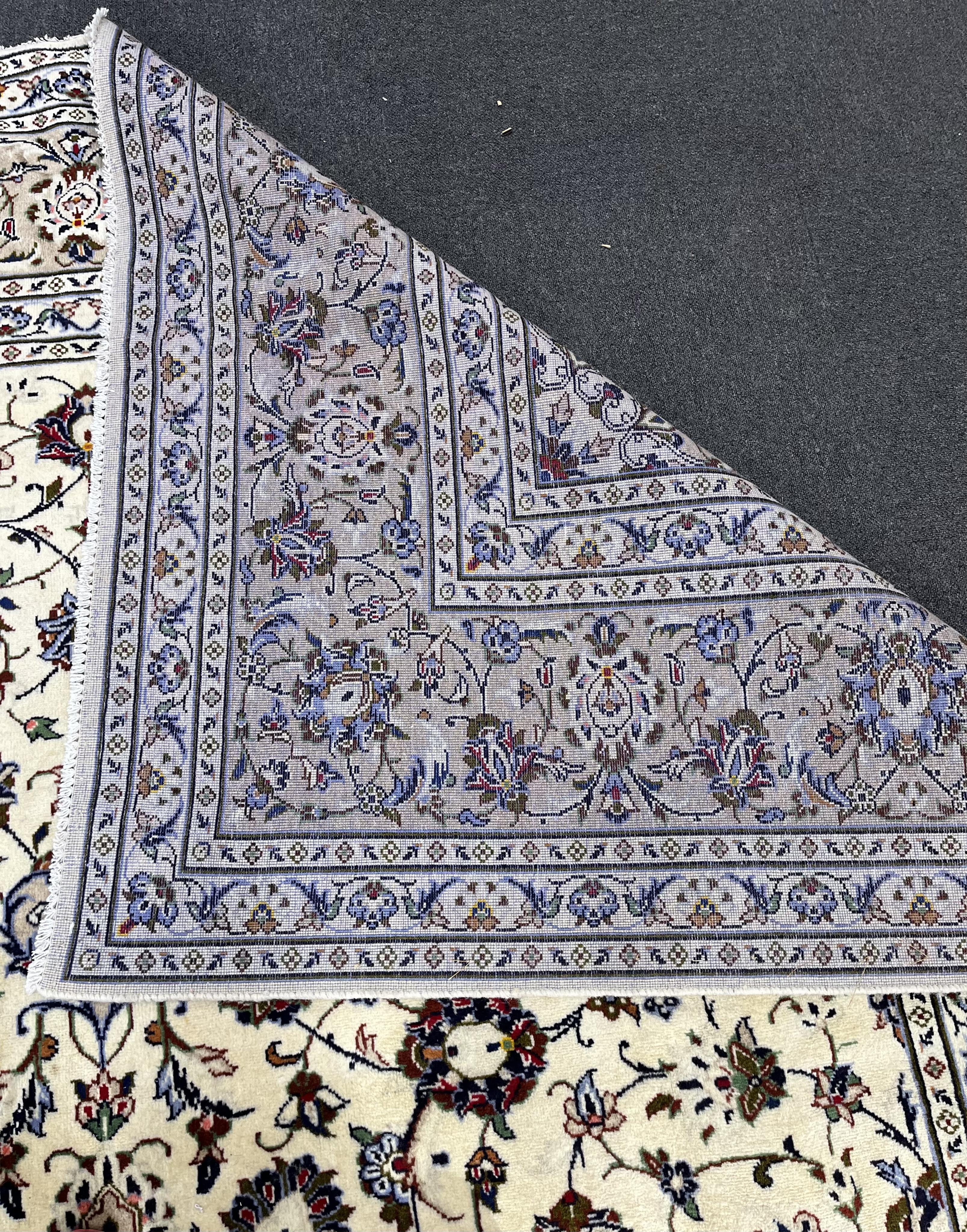 A Kashan ivory ground carpet, 346 x 245. Condition - good